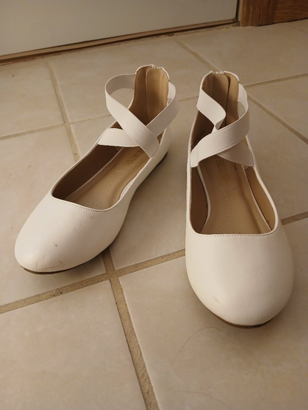 White ballet flats with ankle straps
